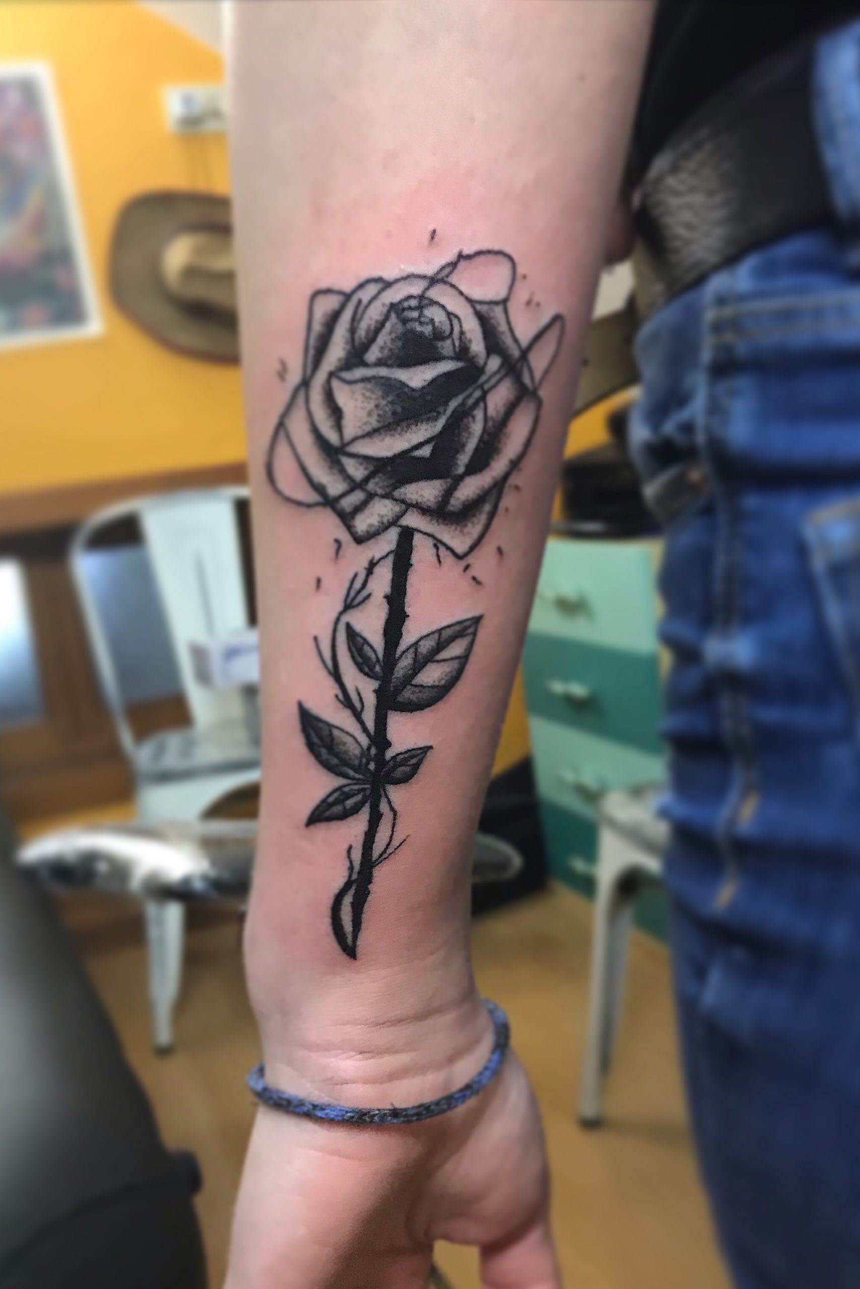 Black rose on arm tatoo