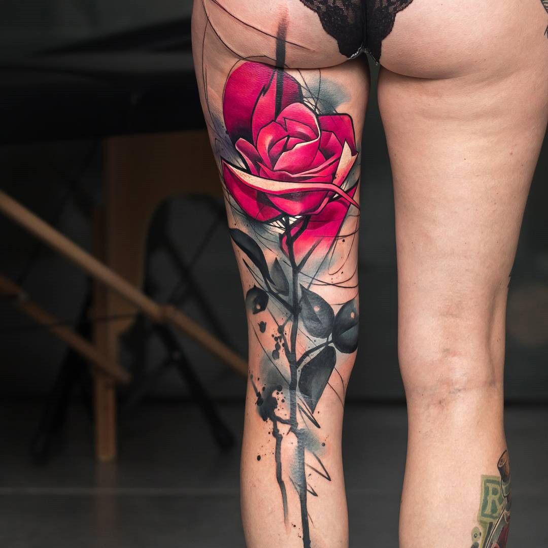 Pink rose tattoo on back of the leg. 