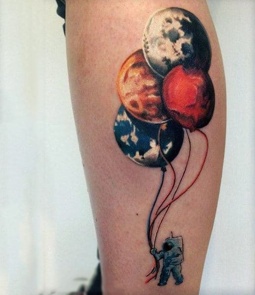 Astronaut with flying planets tattoo